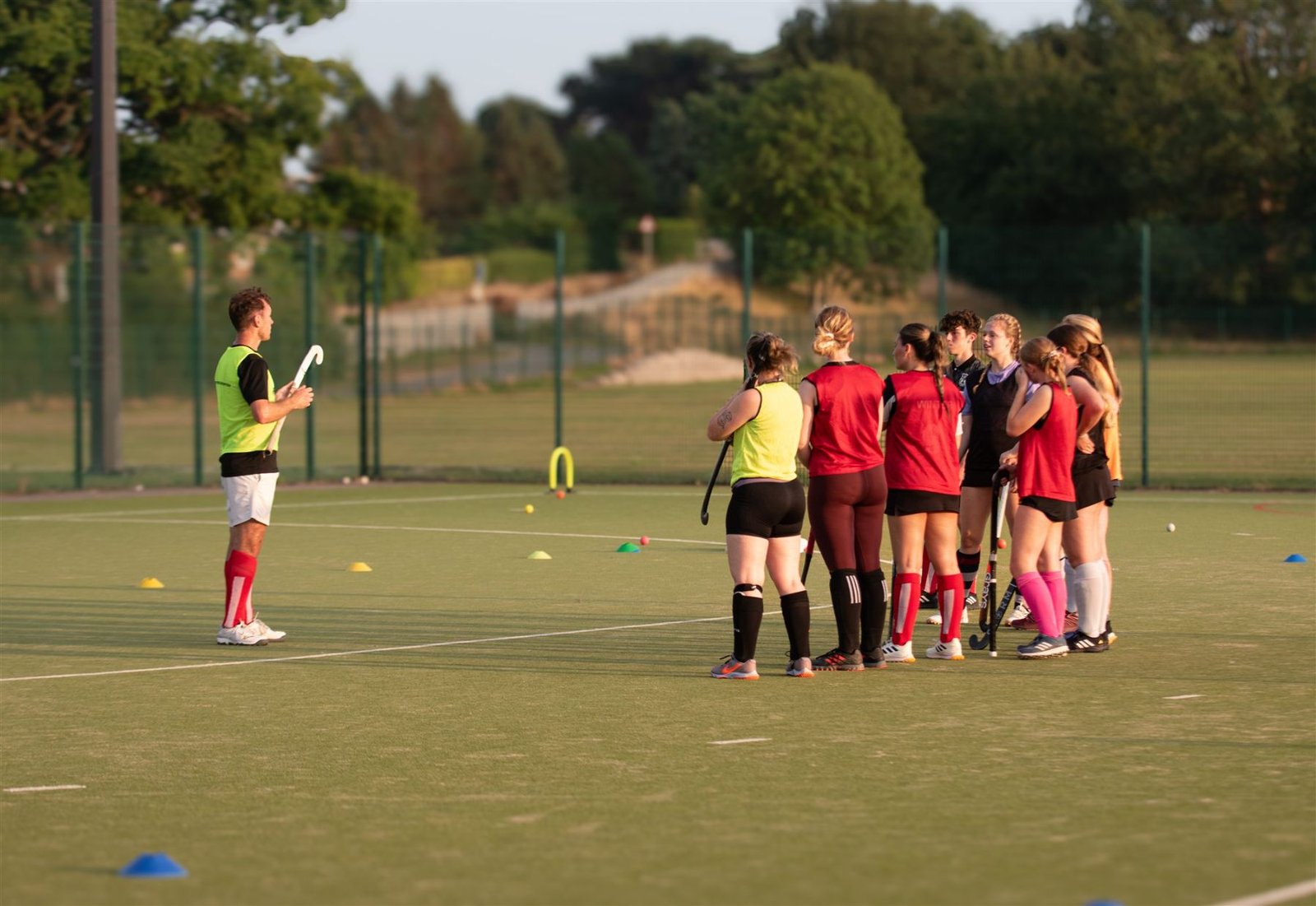 Denbigh players gathered around the coach at training